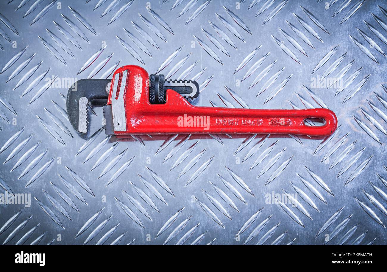 Pipe wrench on fluted metal plate construction concept Stock Photo Alamy