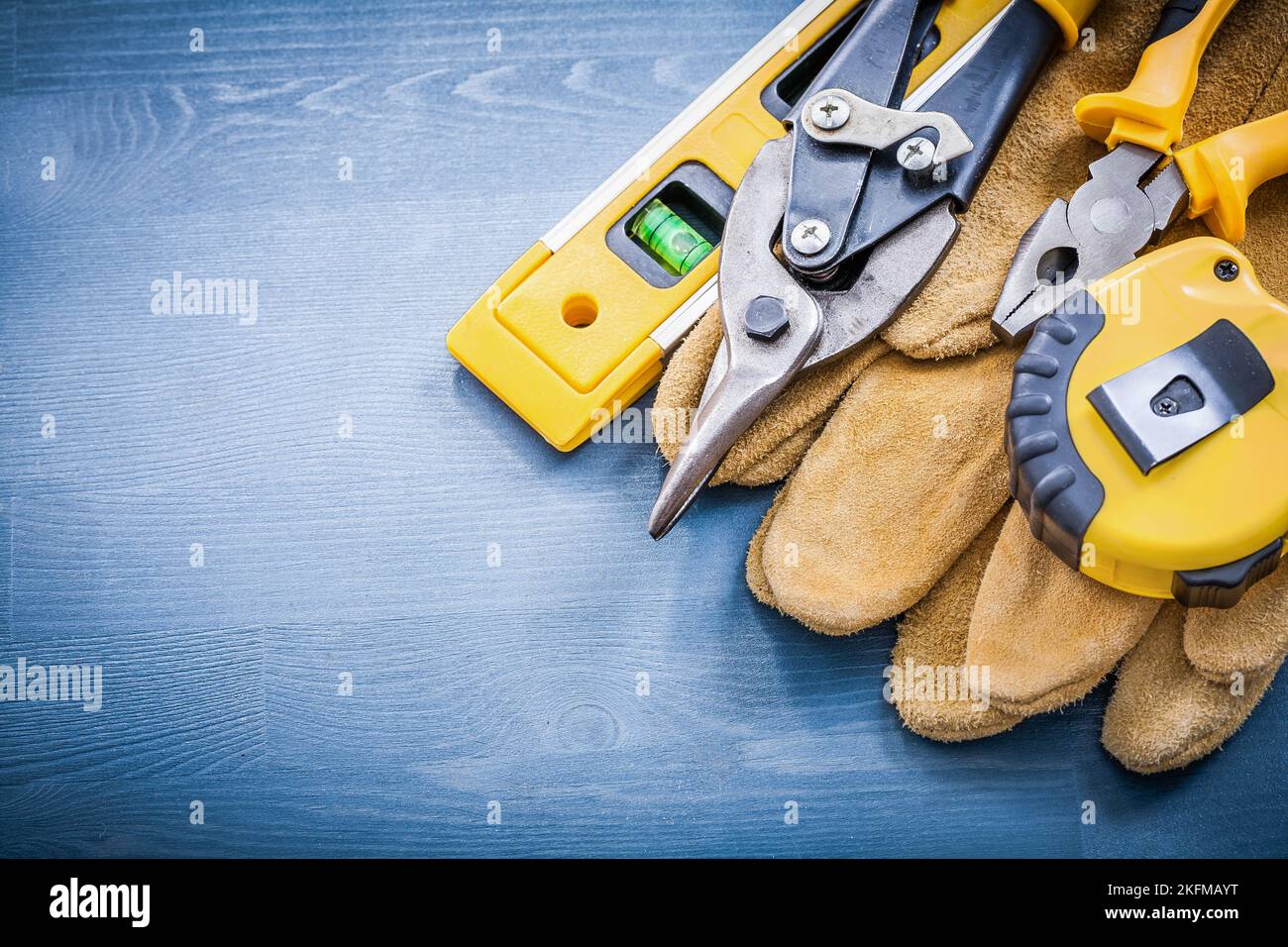 Pliers tin snips tapemeasure construction level safety gloves Stock