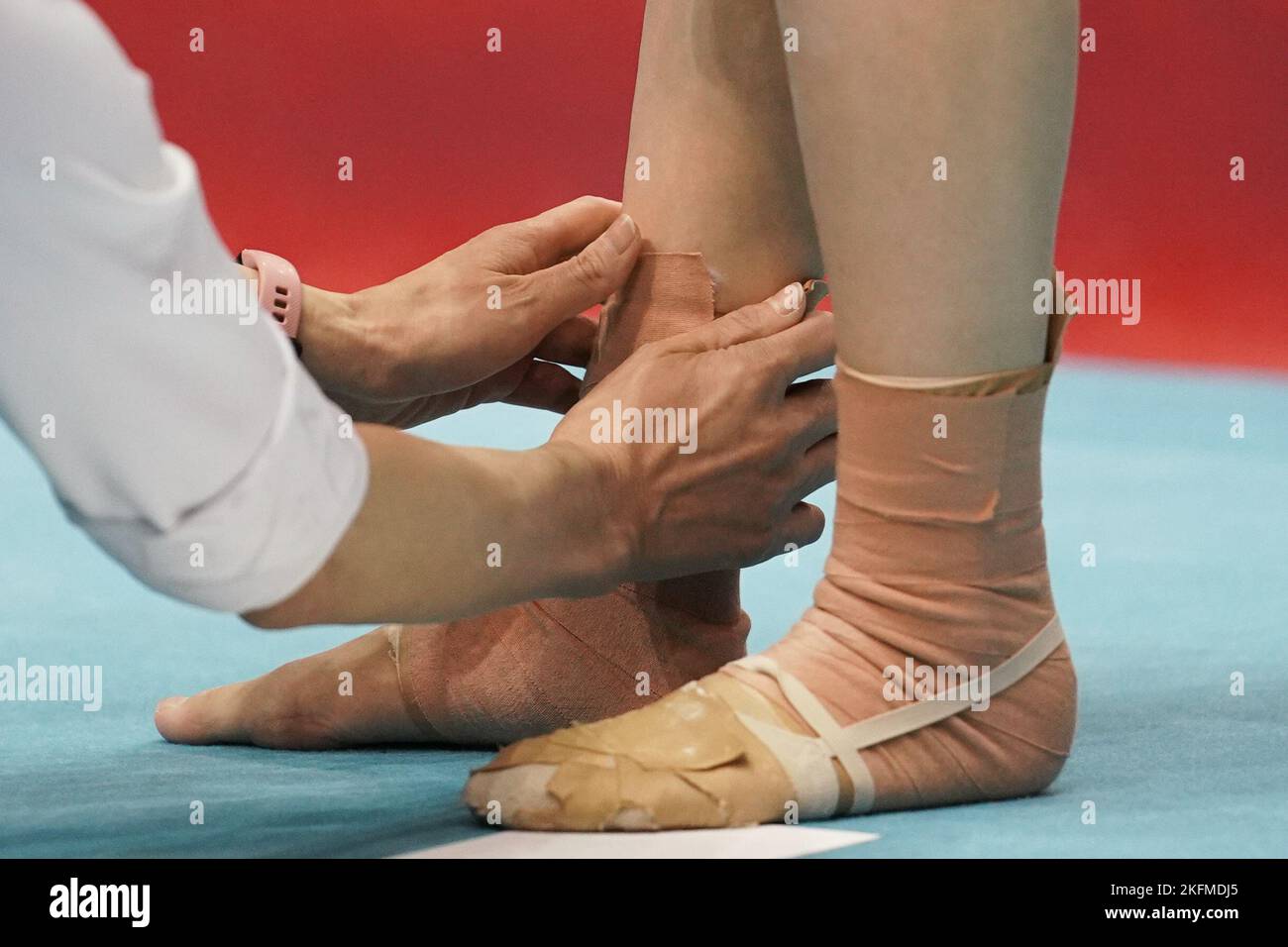 Coach applies strapping to Gymnasts ankles and feet Stock Photo Alamy