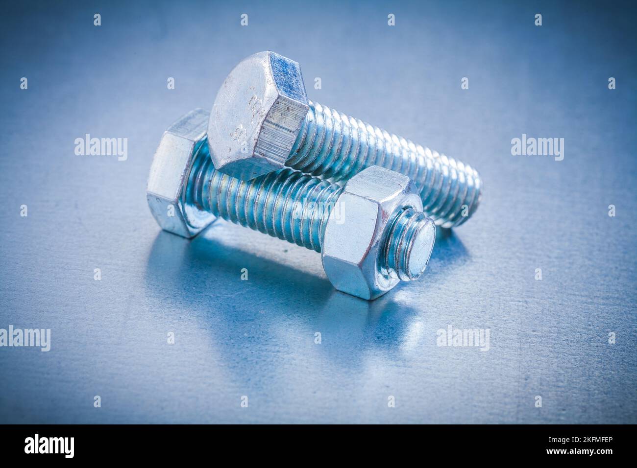 Threaded bolts with screw nut on metallic background construction