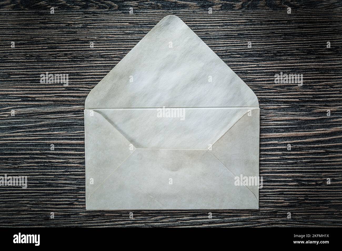 Vintage envelope on black board. Stock Photo