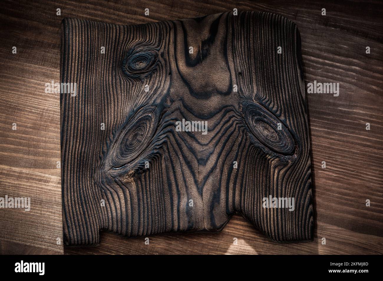 vintage wooden plate on dark wood background Stock Photo