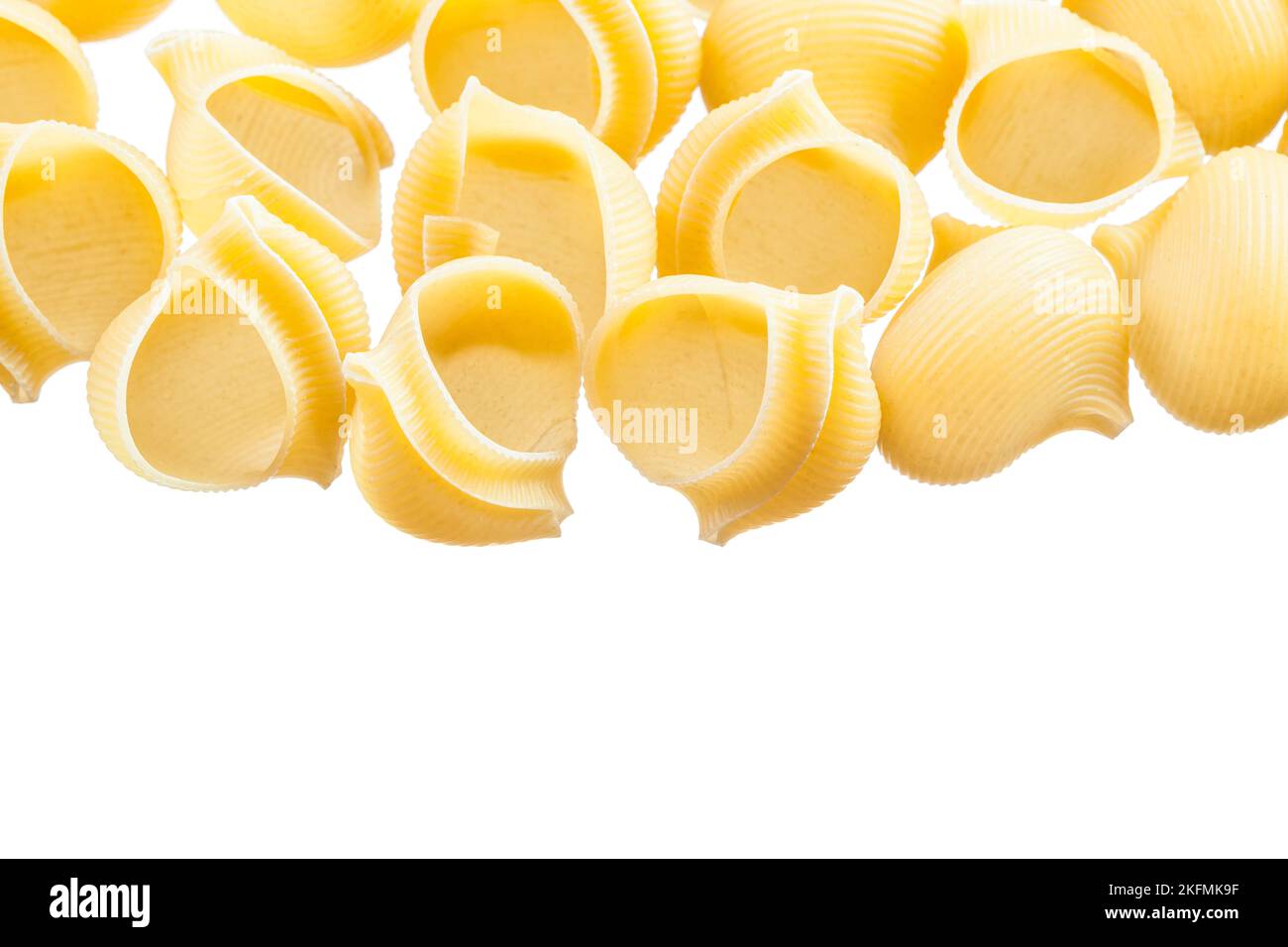 Wholegrain Italian pasta shells isolated on white Stock Photo - Alamy