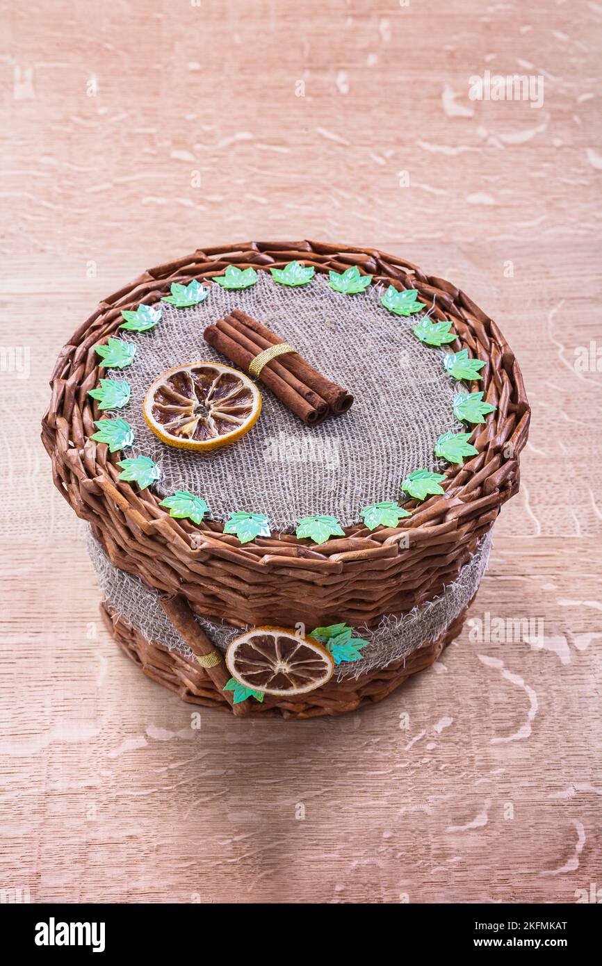 wicker basket without handle on old wooden board Stock Photo