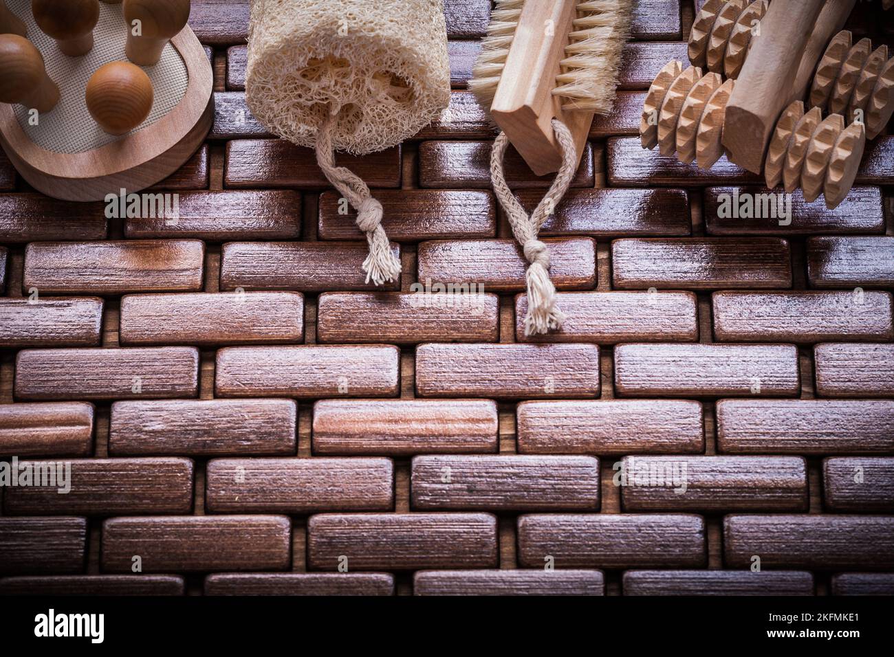 Wood peeling brush massagers and loofah on checked wooden place mat