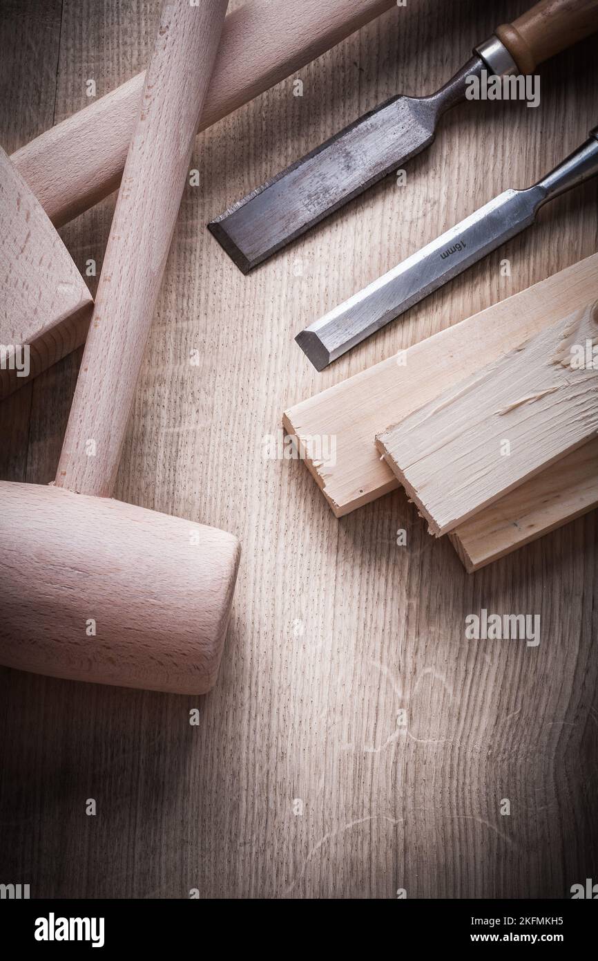Wooden building boards hammers flat chisels on wood background