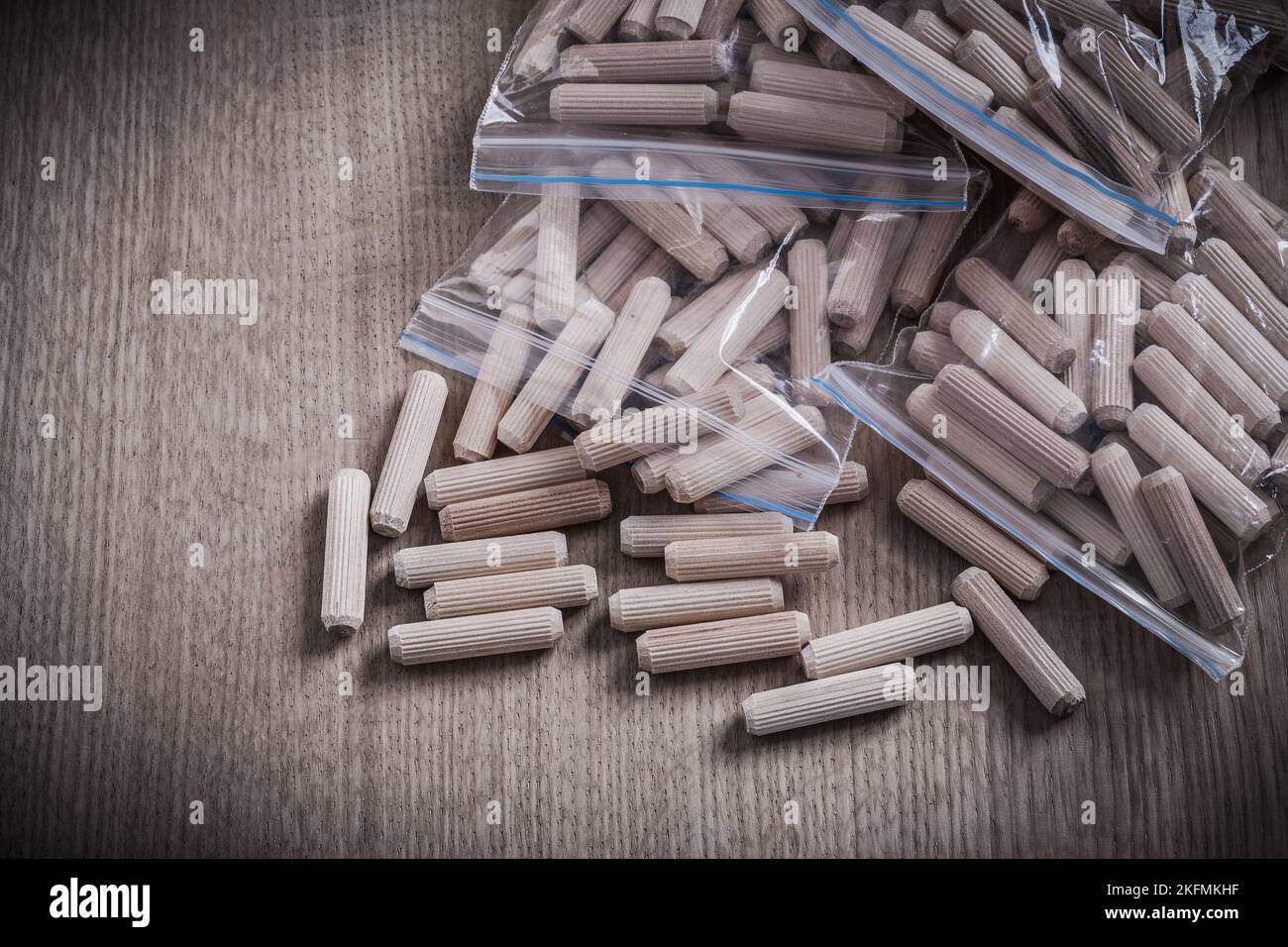 Wooden dowel pins on wood board horizontal version construction concept