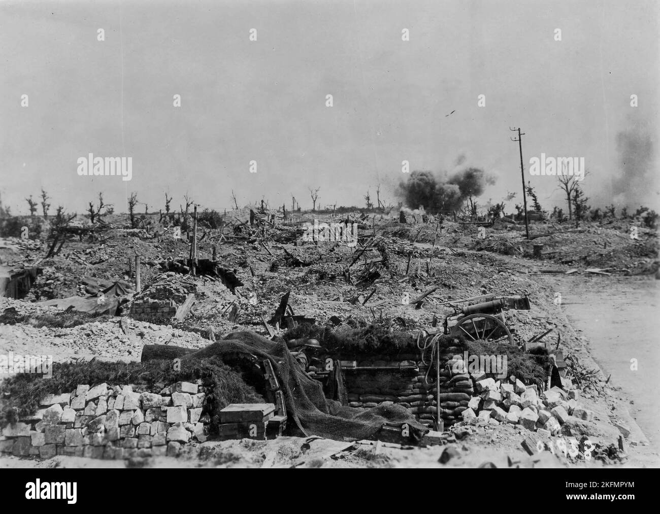 LENS, FRANCE - Jun 1917 - German shells bursting on Canadian positions at Lens, France in June 1917. In the foreground, a Canadian gun pit is camoufla Stock Photo