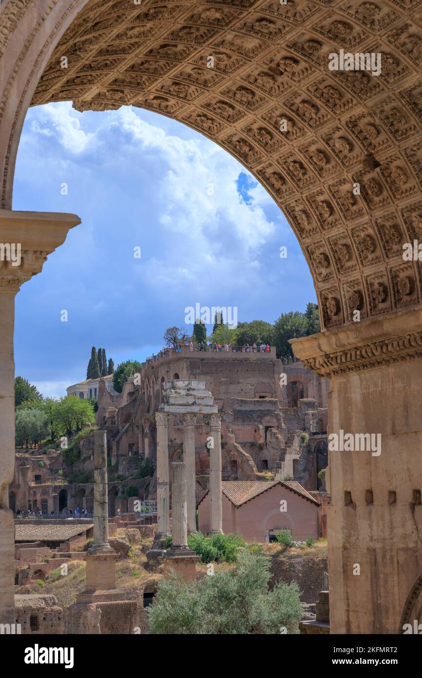 View of the Roman Forum through the Triumphal Arch of Septimius Severus in Rome, Italy. Stock Photo