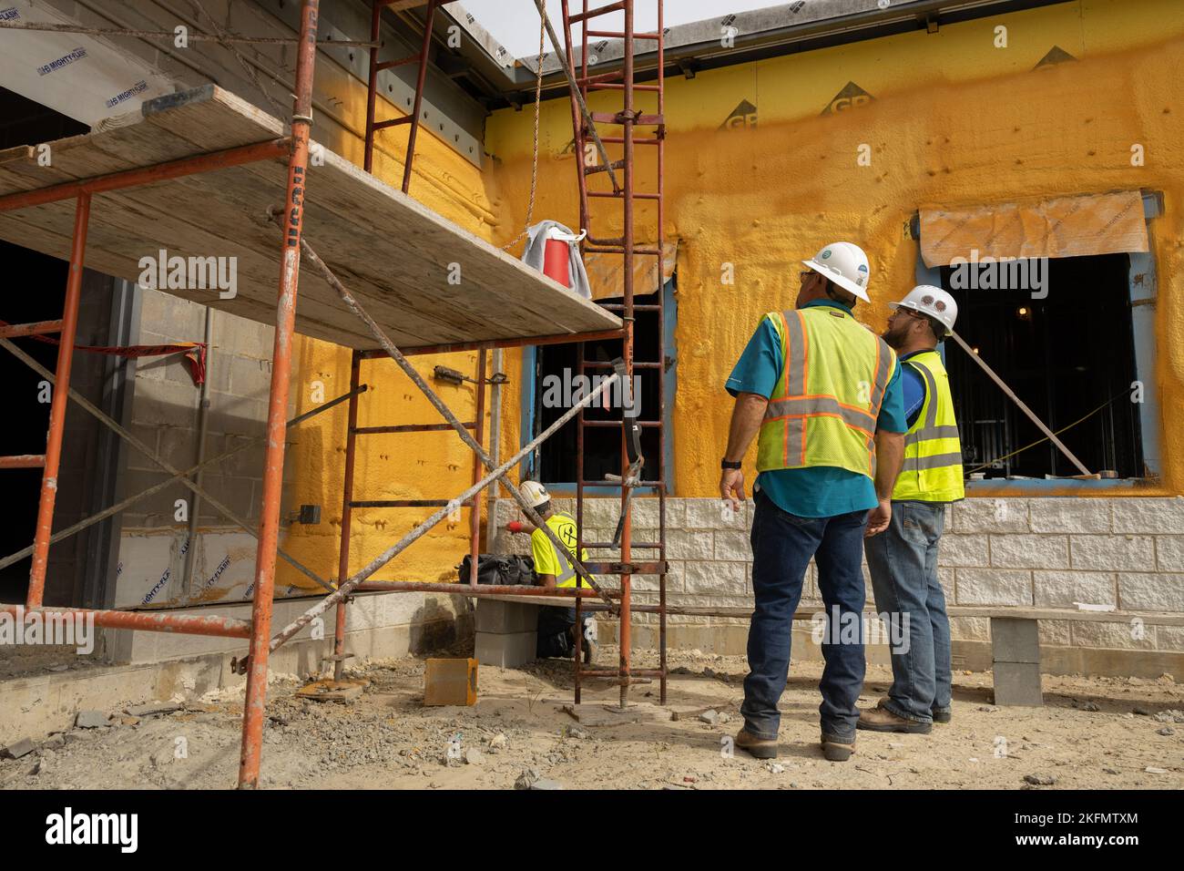 Civilian contractors conduct a site survey of the Courthouse Bay Fire ...