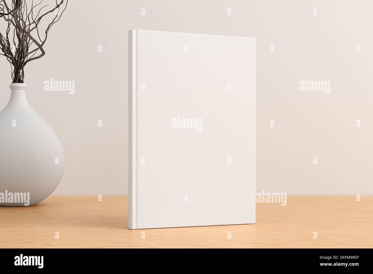 Vertical book cover mock up standing on a wooden desk with white wall background Stock Photo