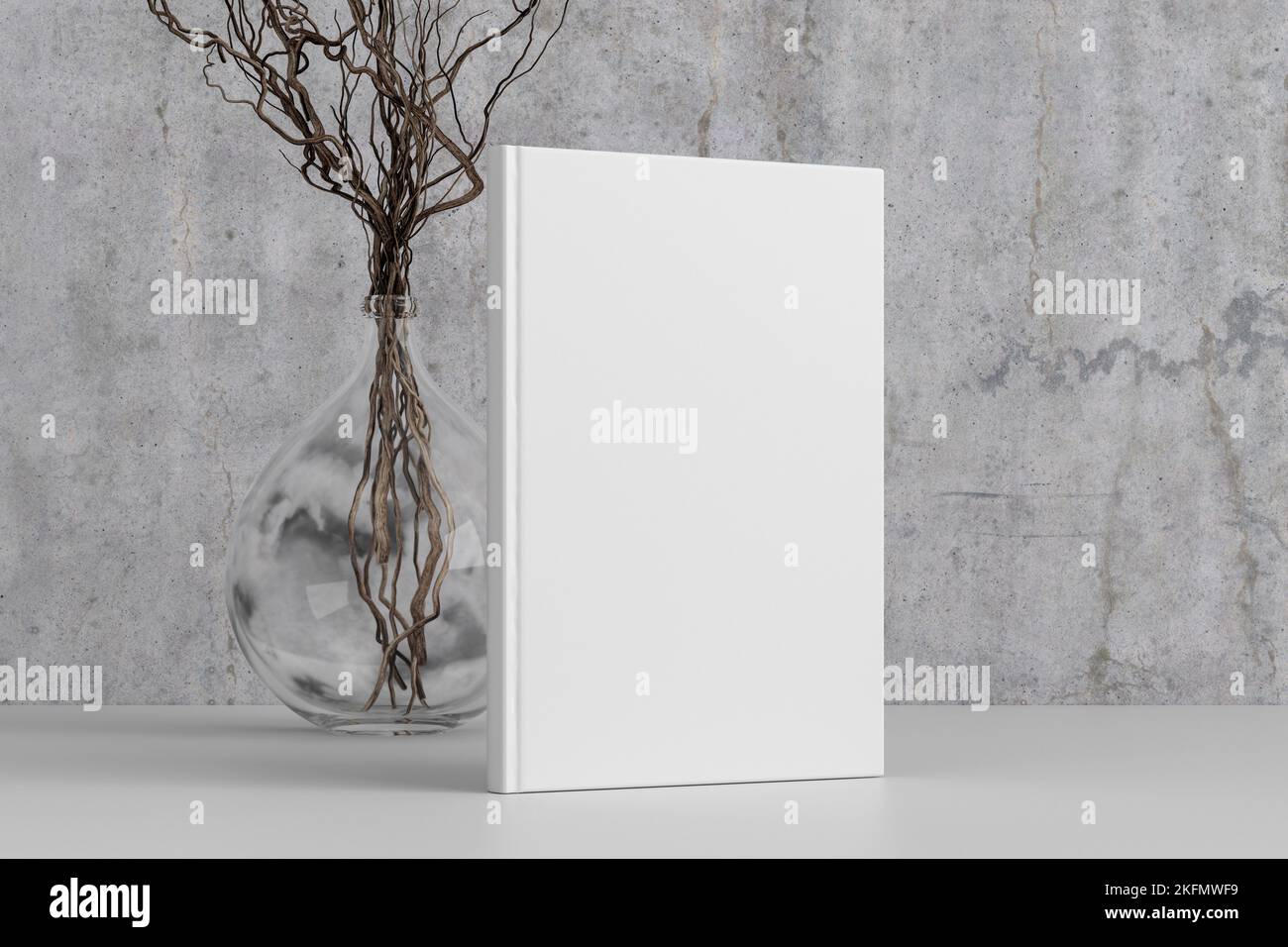 Vertical book cover mock up standing on a white desk with concrete wall background Stock Photo