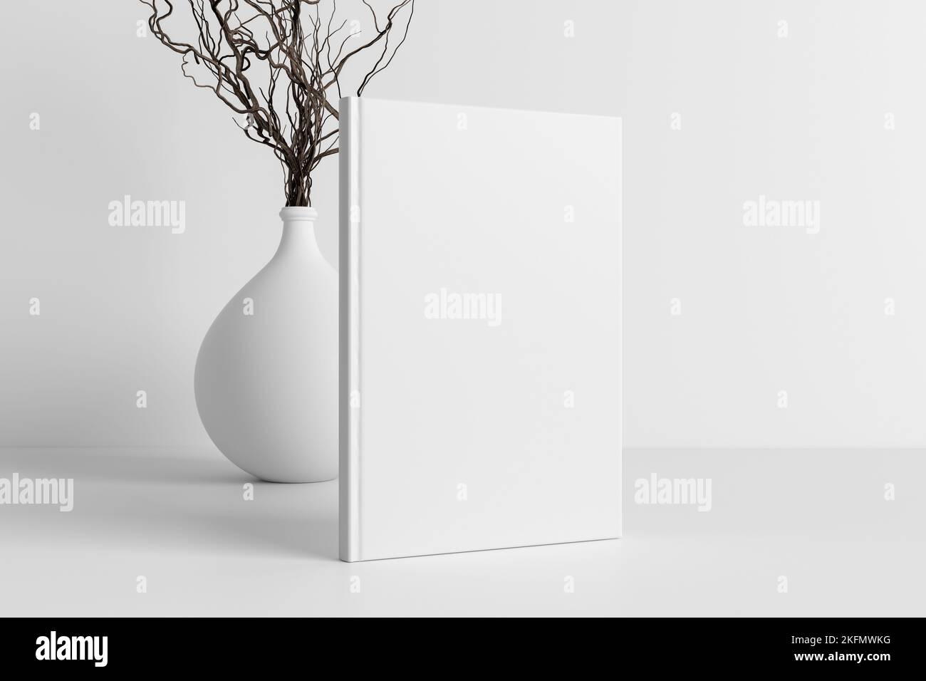 Vertical book cover mock up standing on a white desk with white wall background Stock Photo