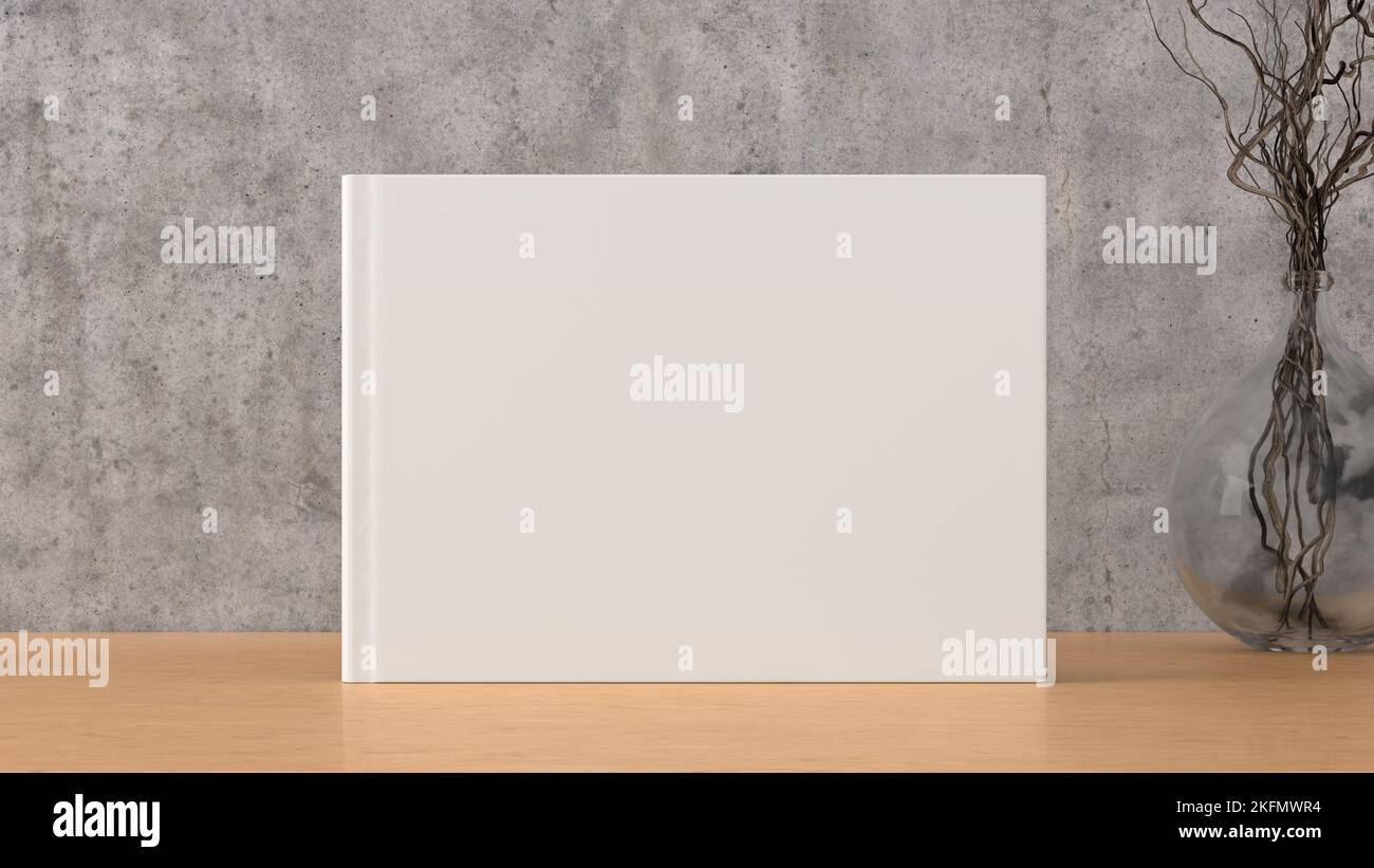 Horizontal book cover mock up standing on a wooden desk with concrete wall background Stock Photo