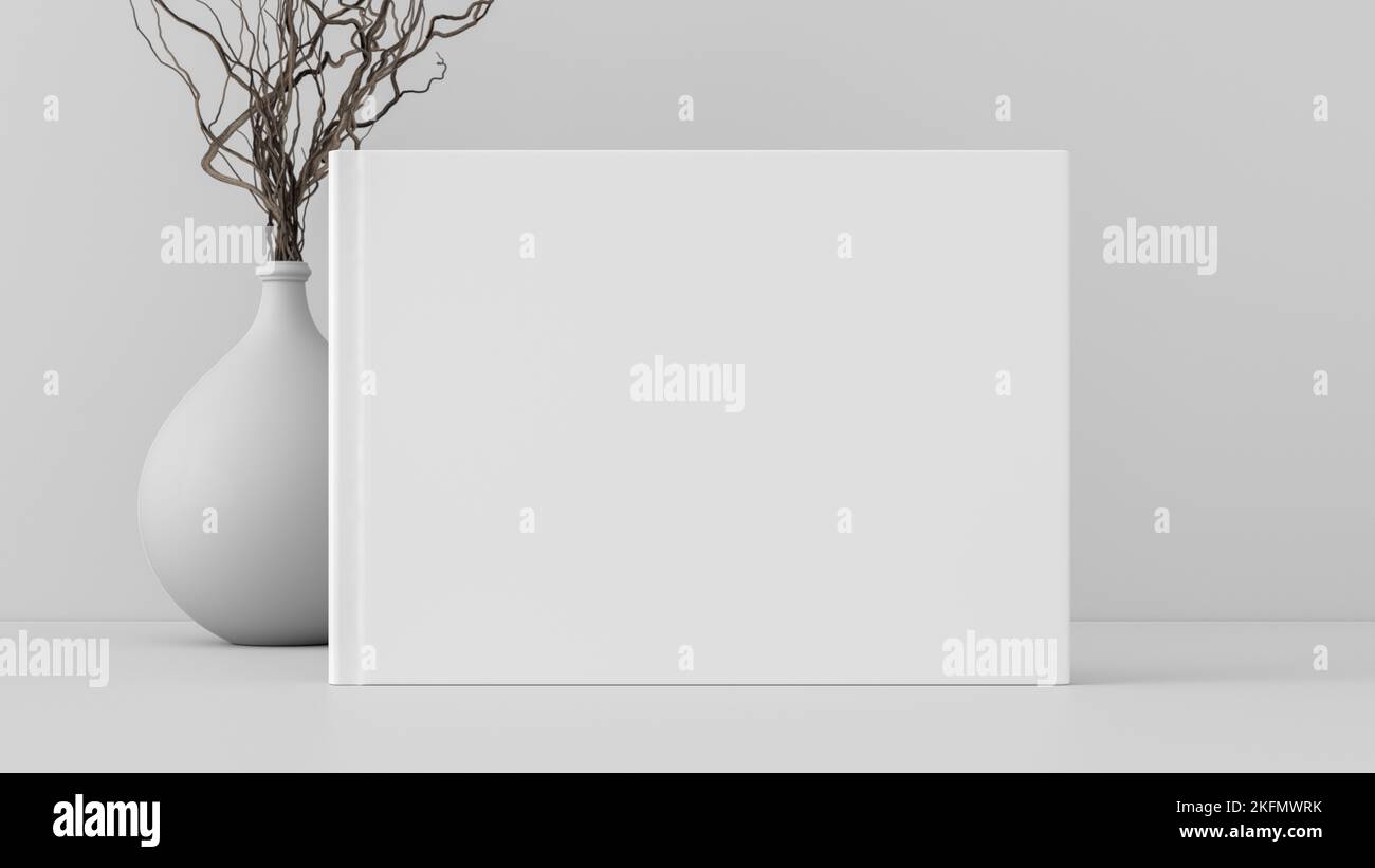 Horizontal book cover mock up standing on a white desk with white wall background Stock Photo