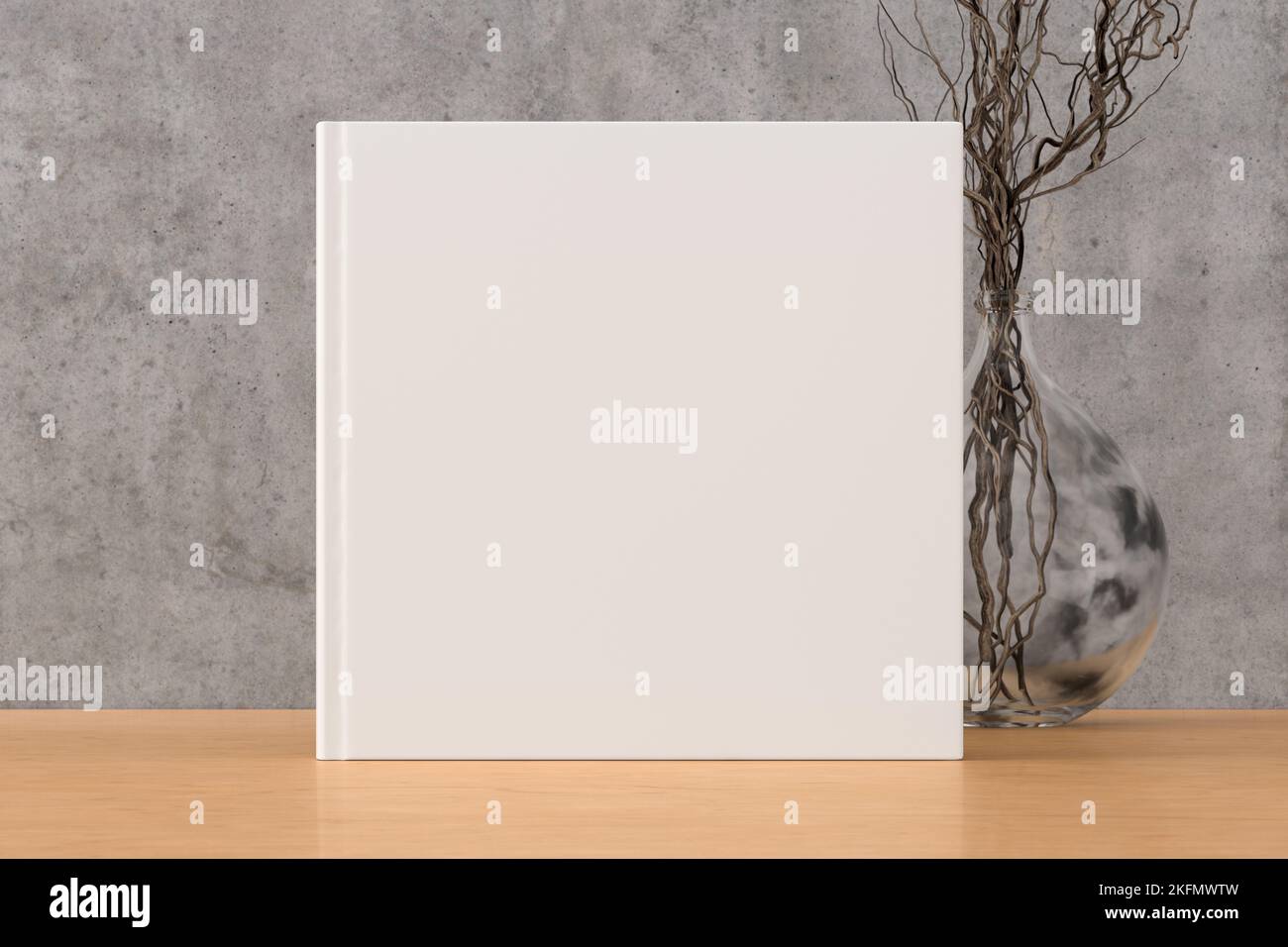 Square book cover mock up standing on a wooden desk with concrete wall background Stock Photo