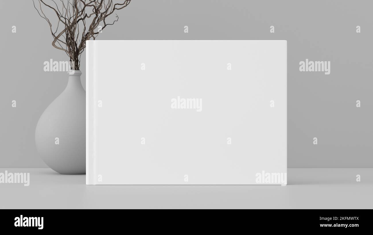 Horizontal book cover mock up standing on a white desk with white wall background Stock Photo
