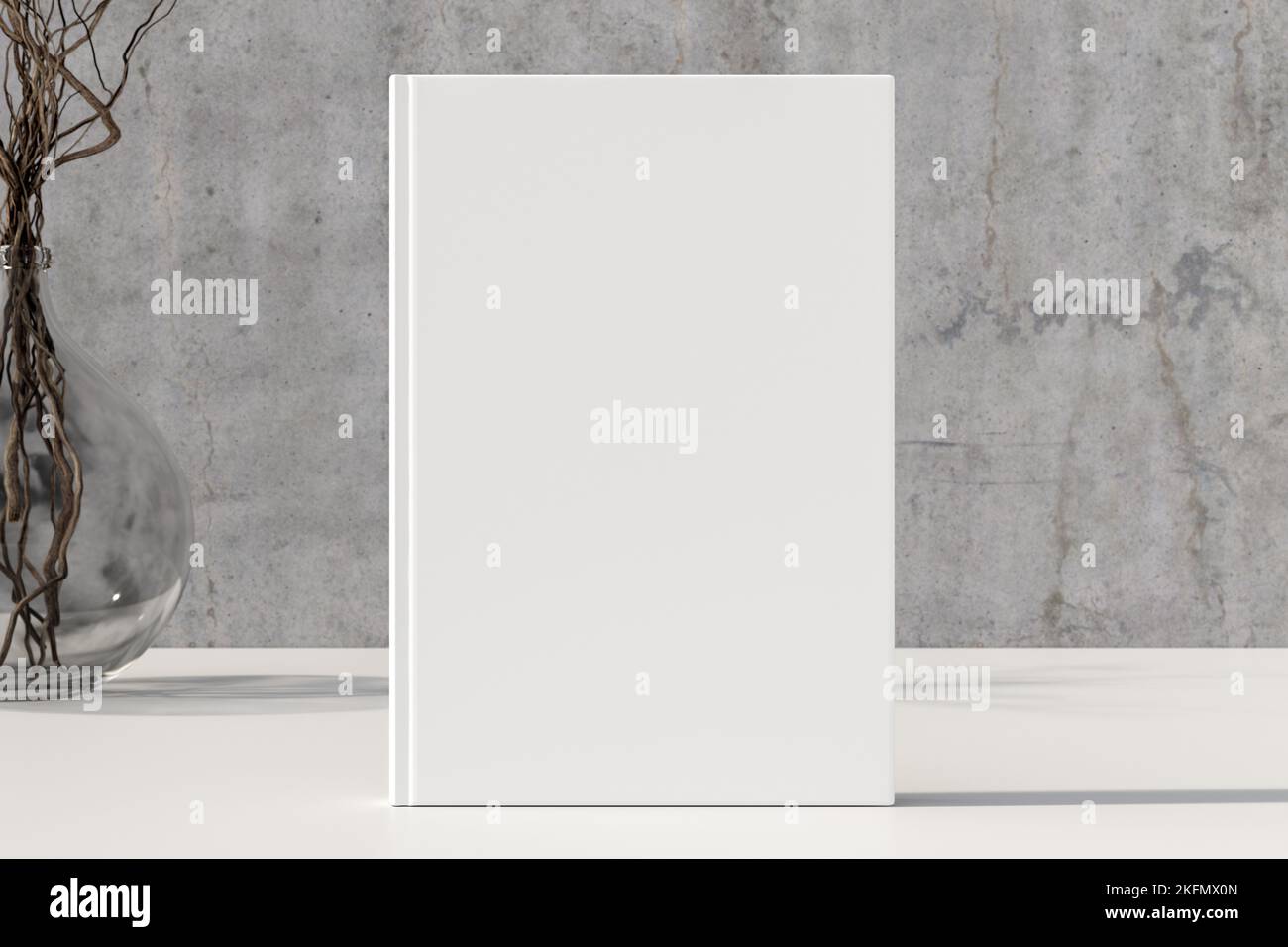 Vertical book cover mock up standing on a white desk with concrete wall background Stock Photo