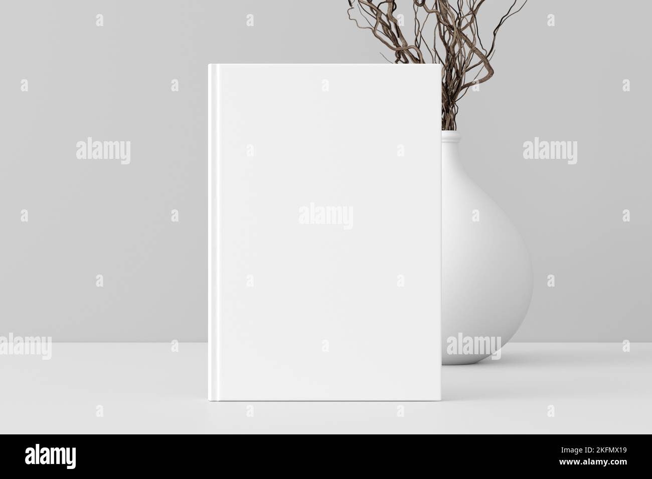 Vertical book cover mock up standing on a white desk with white wall background Stock Photo