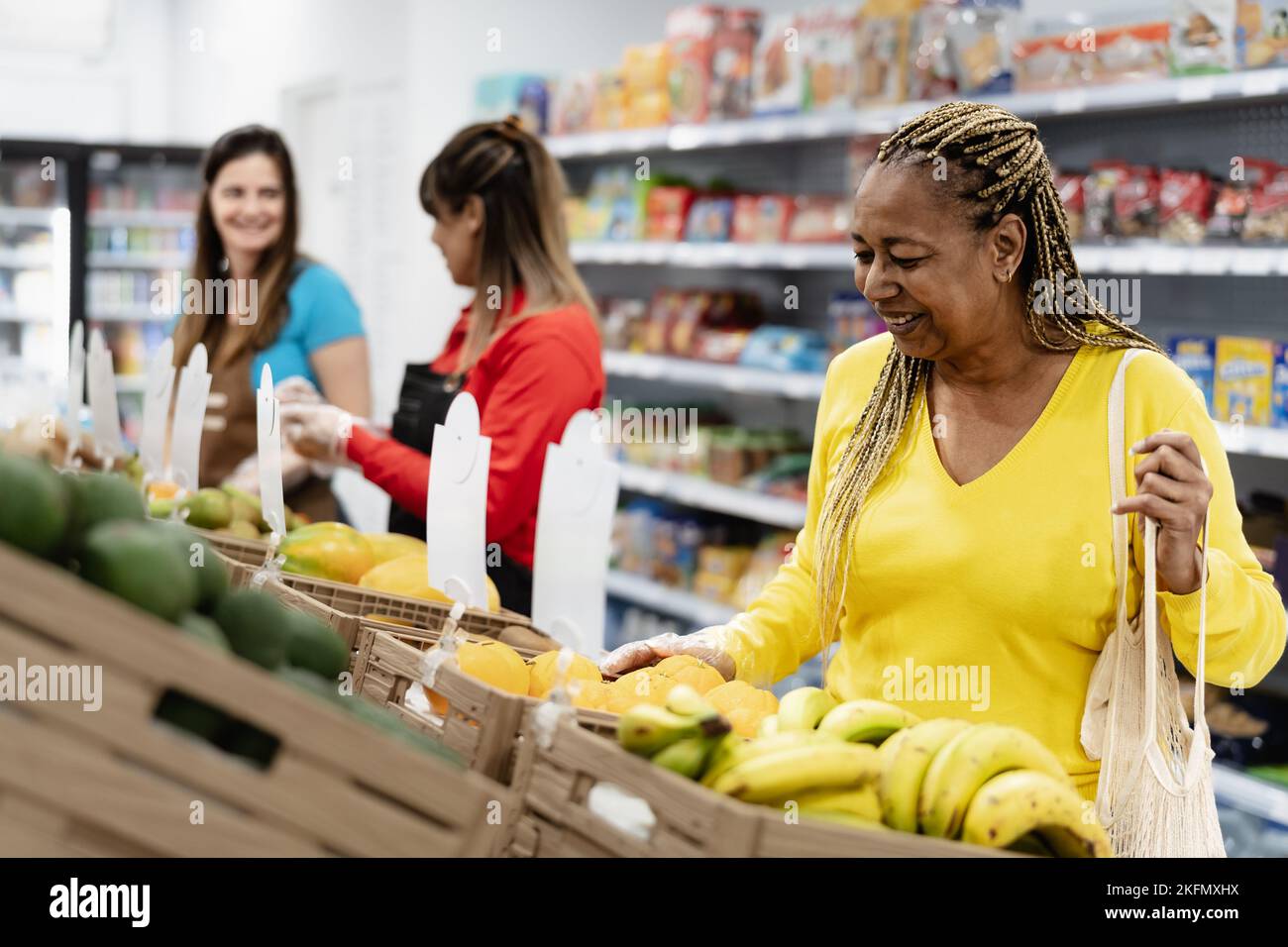Senior African woman buying fresh fruits in supermarket Stock Photo