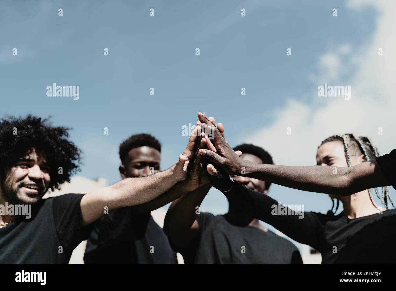 Happy group of African people having fun stacking hands together outdoor Stock Photo