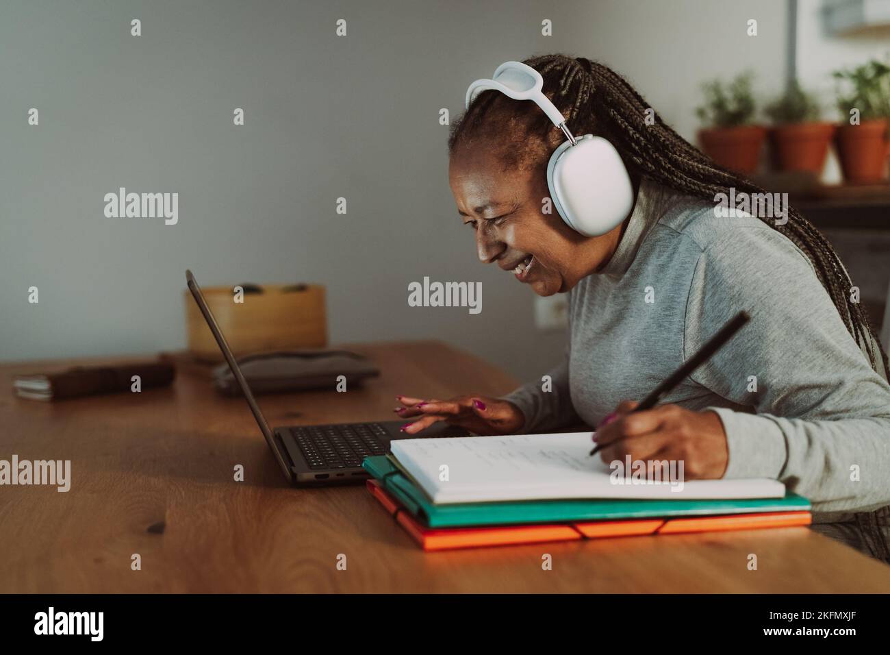 Senior African woman working on a laptop at home - Smart work and Technology concept Stock Photo