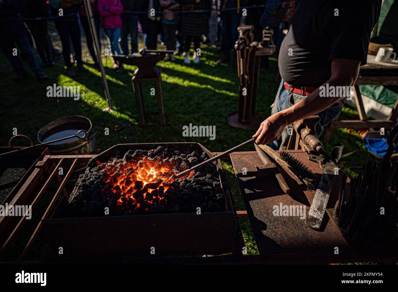 A blacksmith forges steel on the fire at the National Trust's Finch Foundry in Oakhampton, Devon to mark St Clement's Day, the patron saint for blacksmiths. Picture date: Saturday November 19, 2022. Stock Photo
