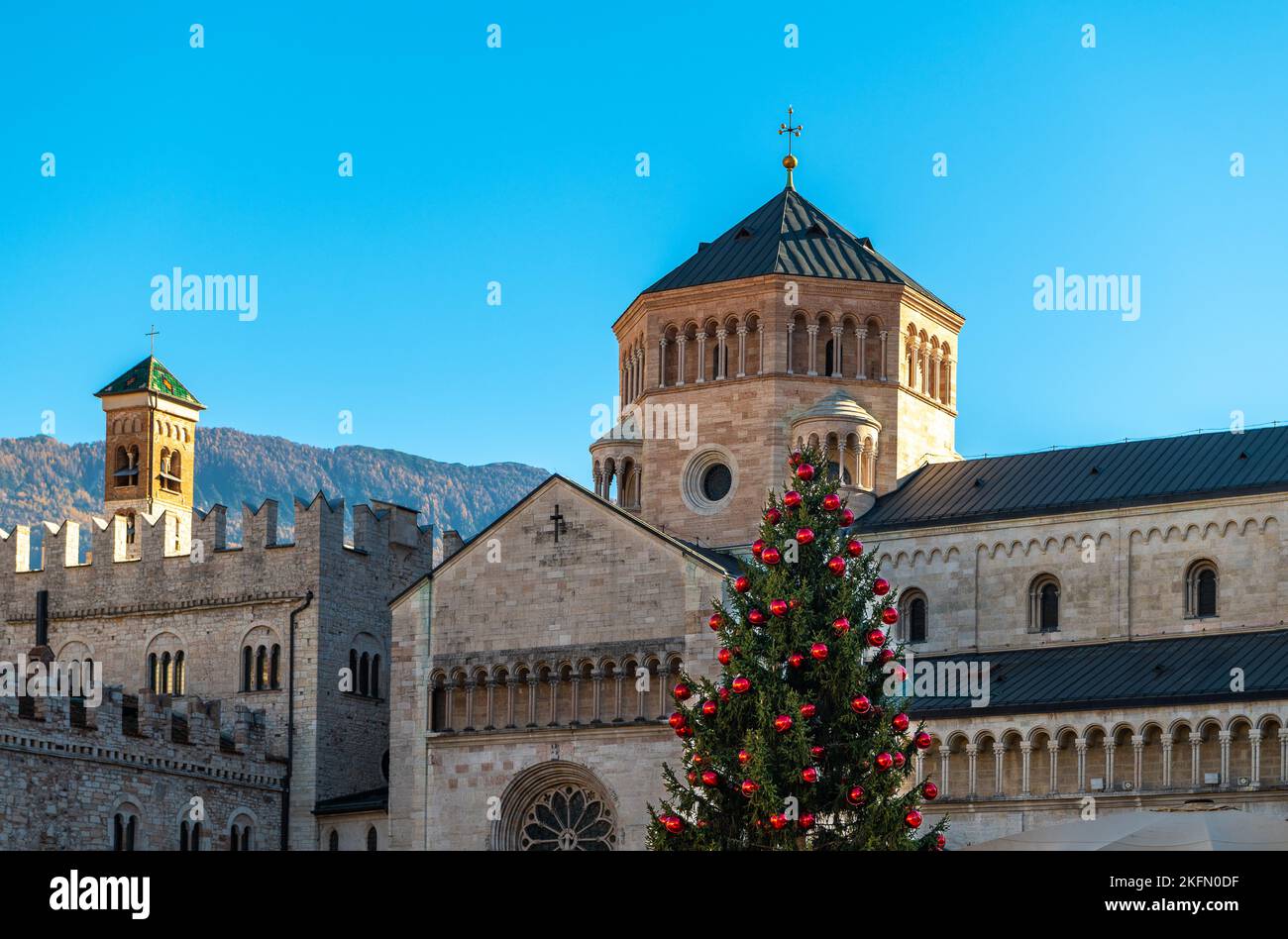 Trento Christmas, Cathedral bell tower in Piazza del Duomo in Trento with Christmas tree - Trento city, Trentino Alto Adige - northern Italy, Stock Photo