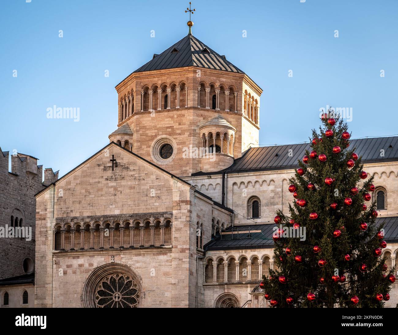 Trento Christmas, Cathedral bell tower in Piazza del Duomo in Trento with Christmas tree - Trento city, Trentino Alto Adige - northern Italy, Stock Photo