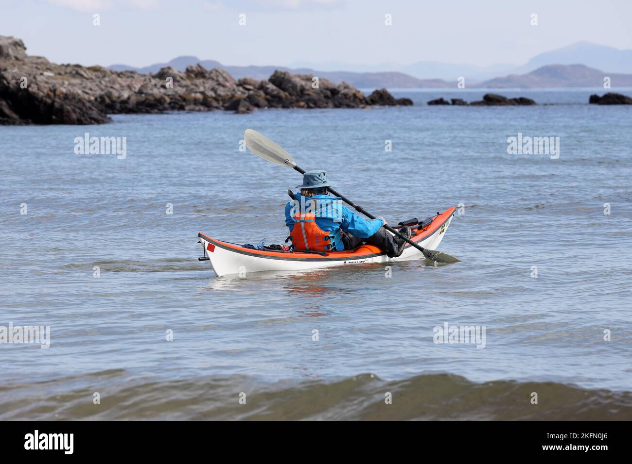 Person Paddling a Sea Kayak of the Coast at Mellon Udrigle, Wester Ross, Scotland, UK Stock Photo