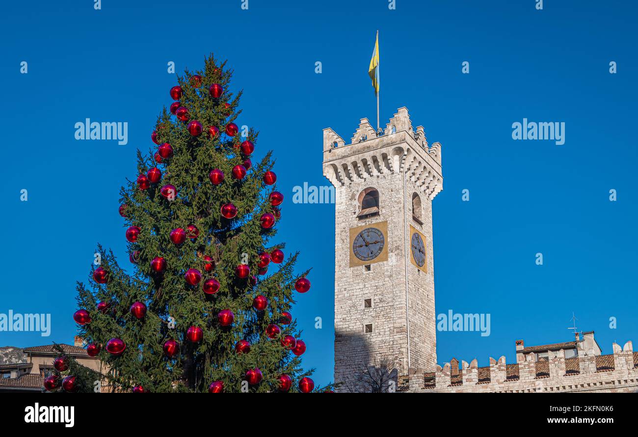 Trento Christmas, Cathedral bell tower in piazza del Duomo in Trento with Christmas tree - Trento city, Trentino Alto Adige - northern Italy, Stock Photo