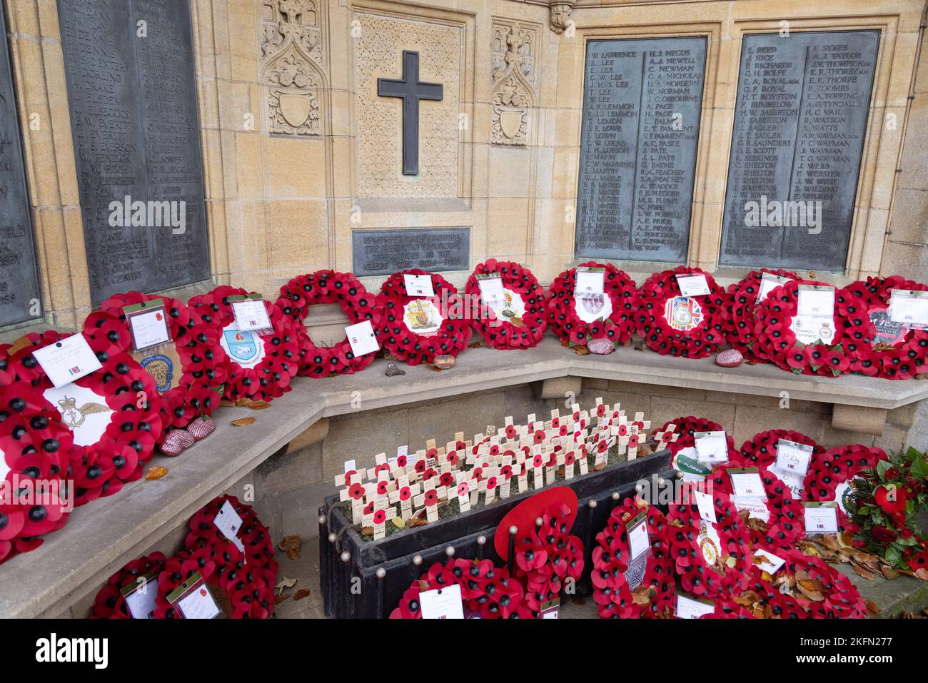 Remembrance Day UK, 11th November; War Memorial decked with poppies in memory of the dead in the World Wars and other conflicts; Ely Cambridgeshire En Stock Photo