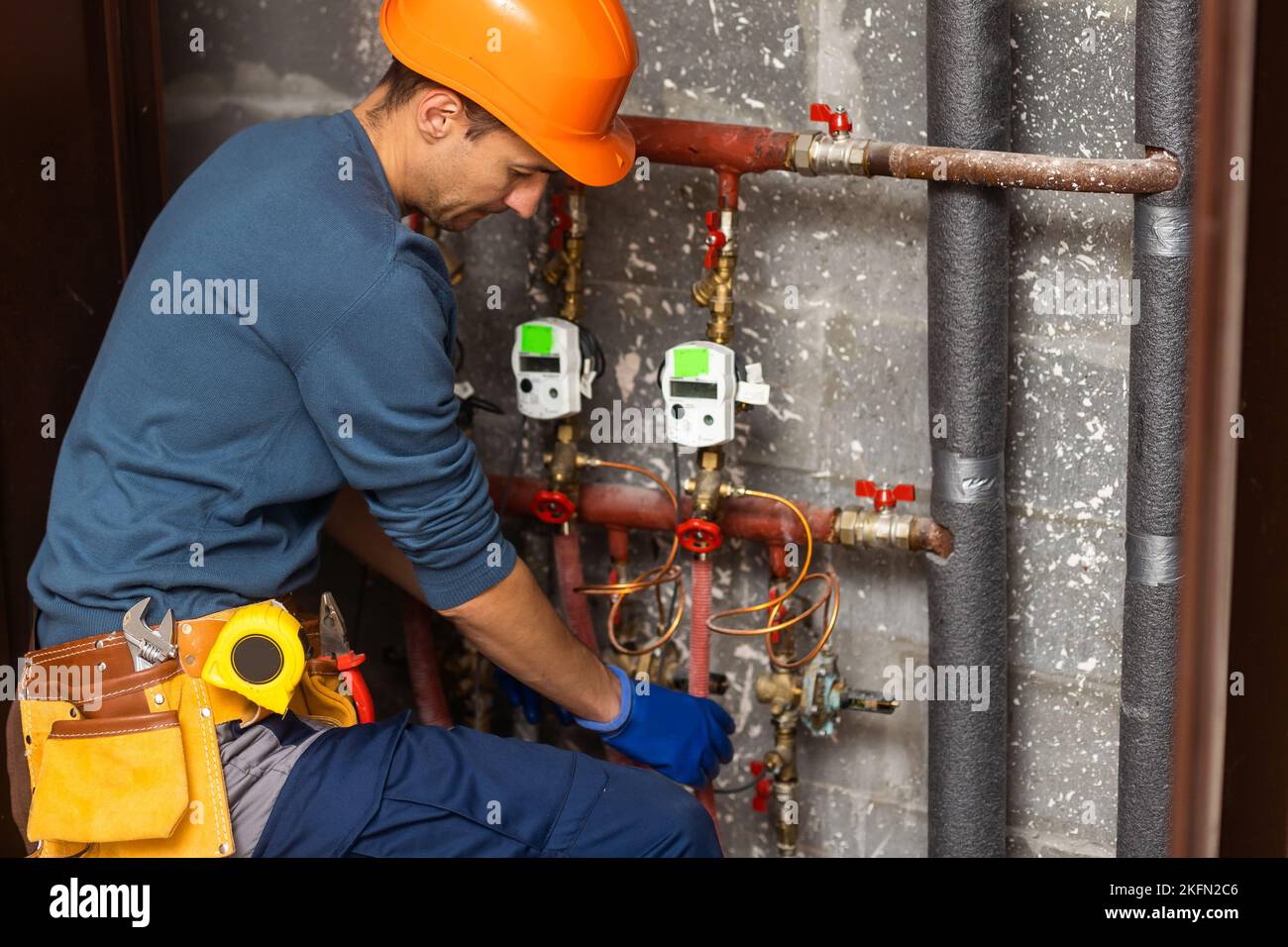 Maintenance engineer checking technical data of heating system