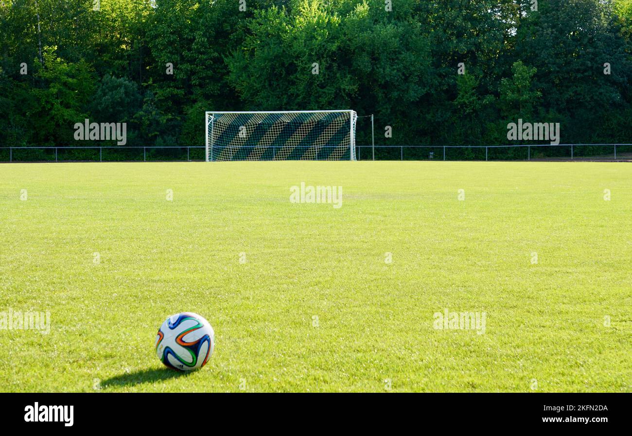 A football, soccer ball set on green lawn in a match field ready for