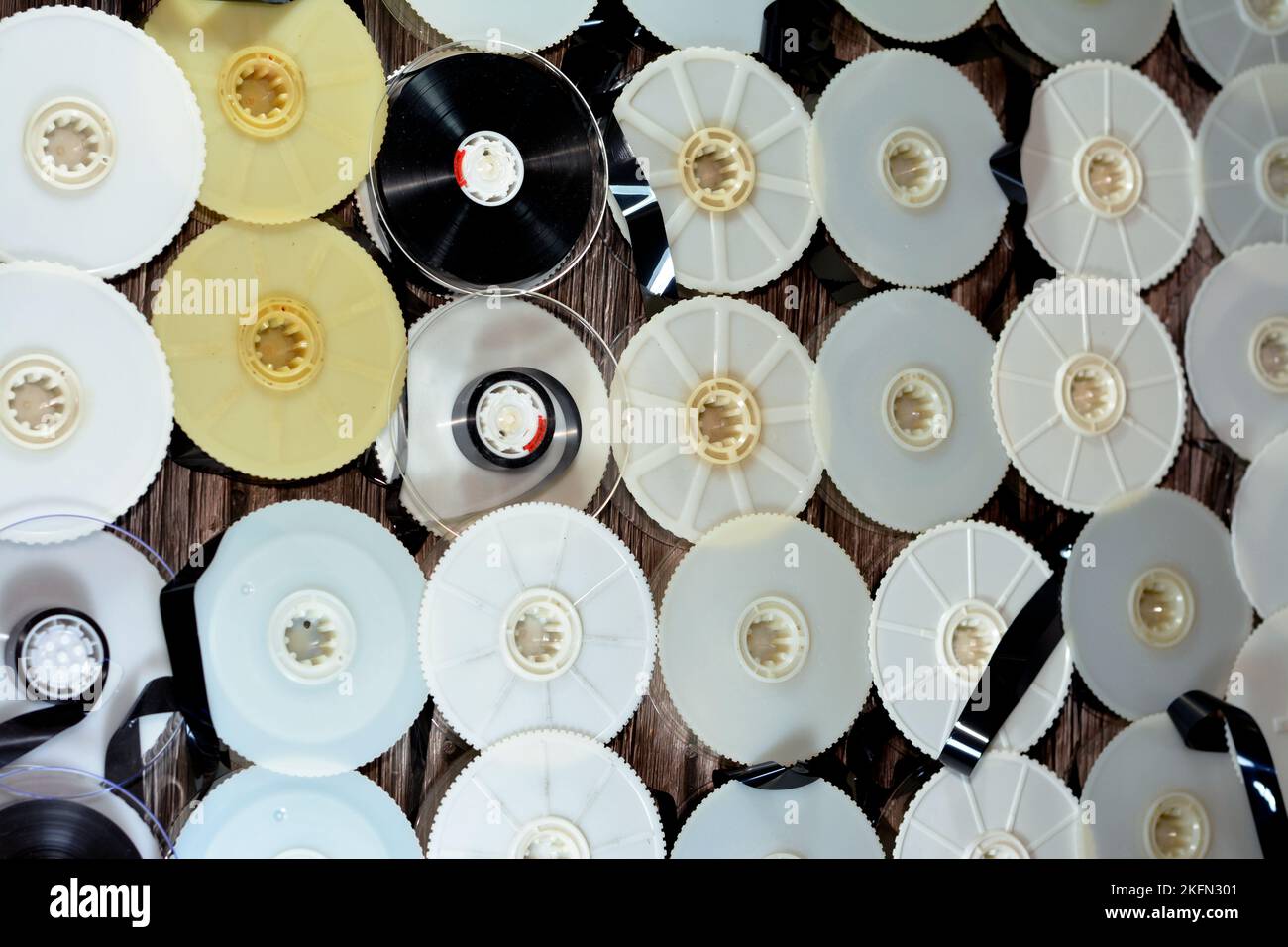 Stack of supply and take up reels with ribbon of VHS video cassette