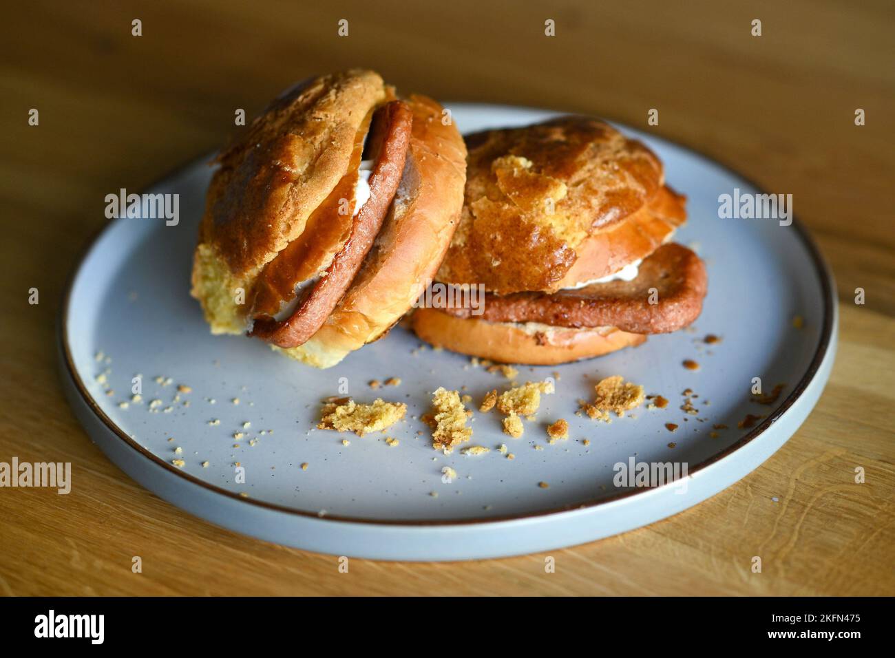 Bolo Bum or Pineapple Bun with a vegetarian "Meat" slice inside. London. UK. November 2022 Stock