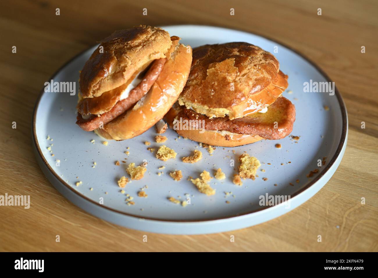 Bolo Bum or Pineapple Bun with a vegetarian "Meat" slice inside. London. UK. November 2022 Stock