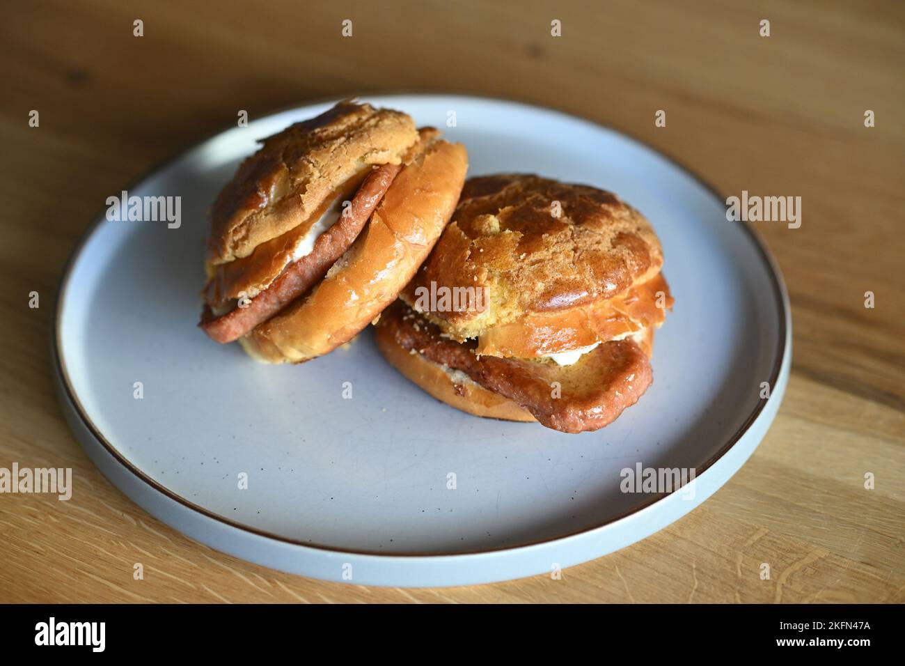 Bolo Bum or Pineapple Bun with a vegetarian "Meat" slice inside. London. UK. November 2022 Stock