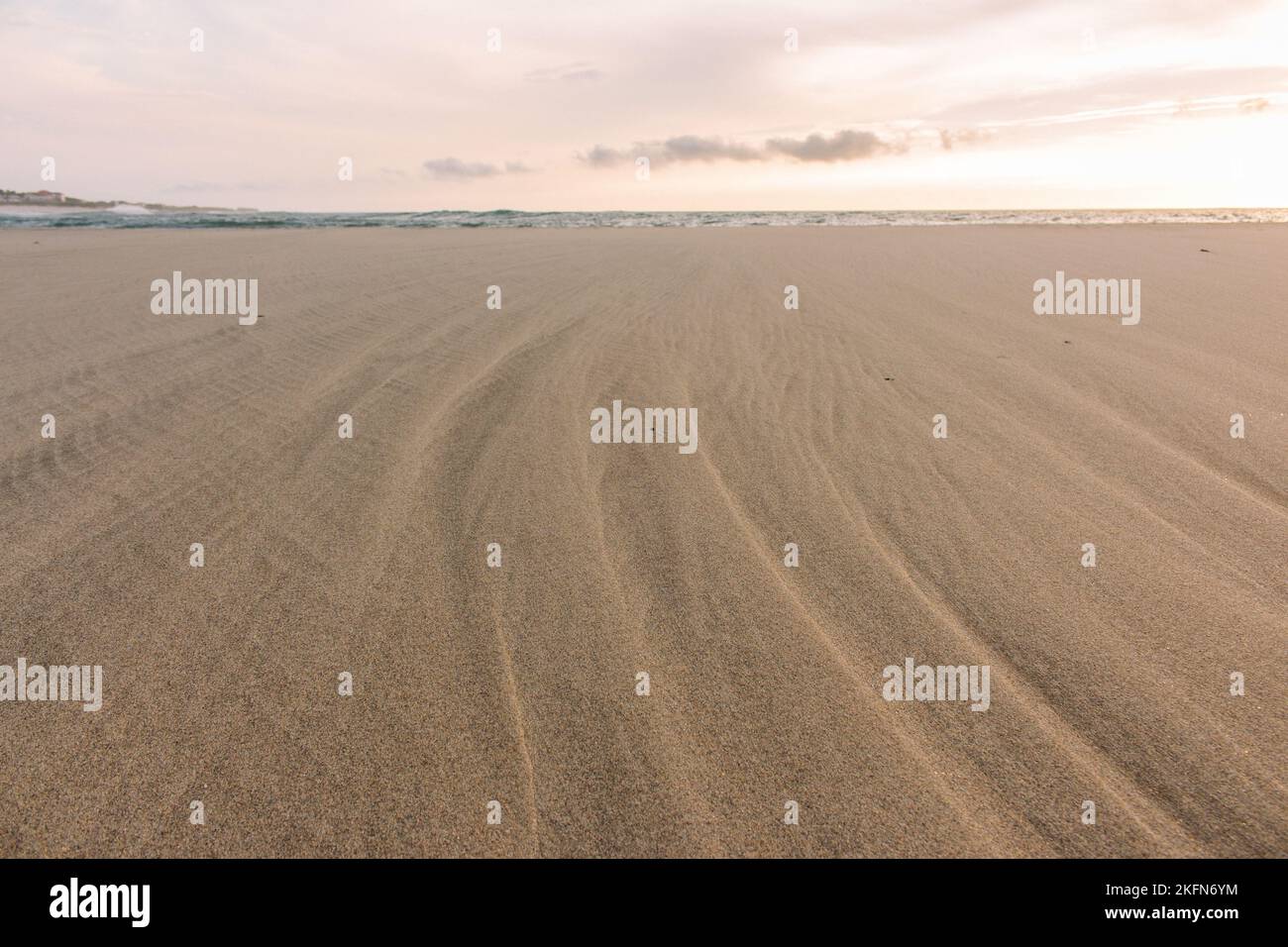 Empty beach on low tide. Seaside with curvy sand. Low tide in lagoon