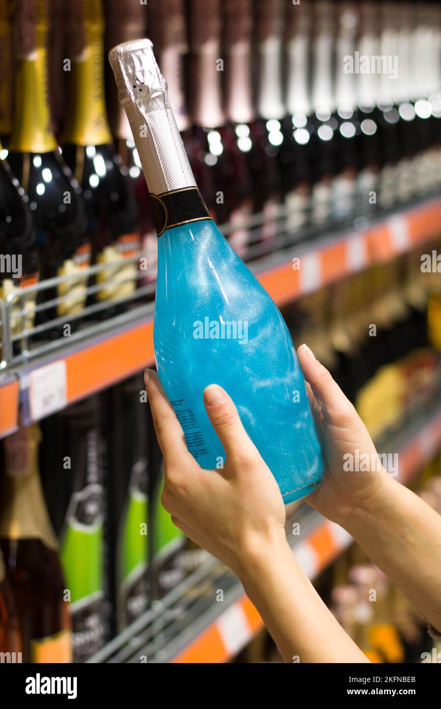 women's hands hold a bottle of alcohol Stock Photo Alamy