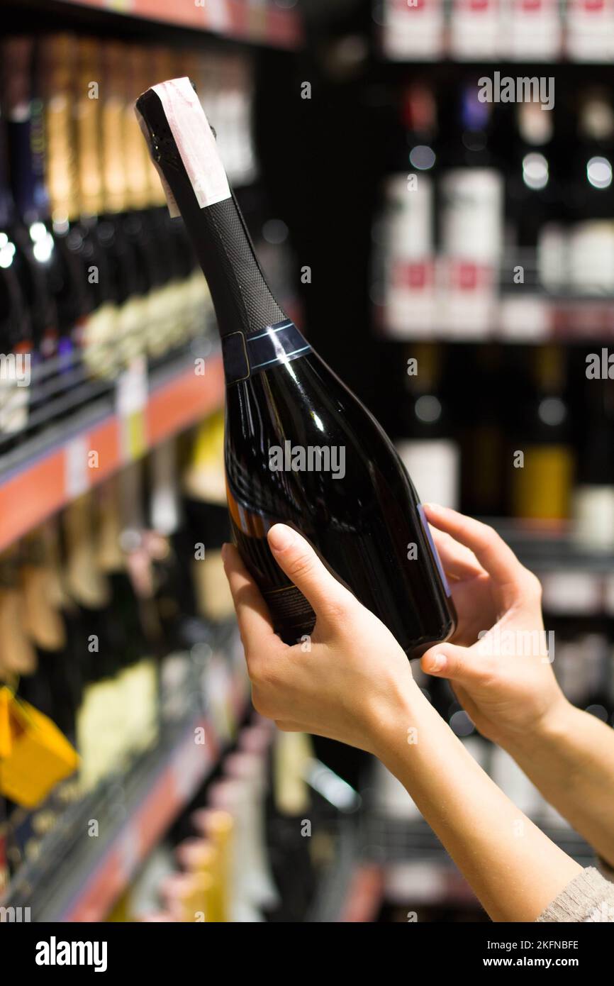 women's hands hold a bottle of alcohol Stock Photo Alamy