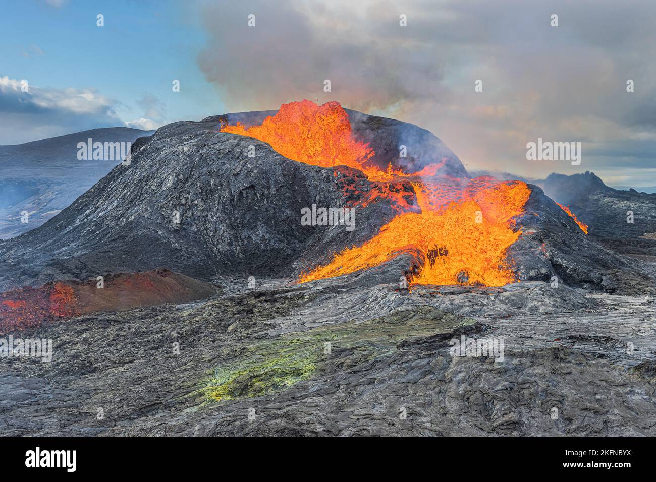Landscape in Iceland of Reykjanes Peninsula. View of an active volcano with glowing lava. Volcanic crater to erupt during the day with sunshine. Stock Photo