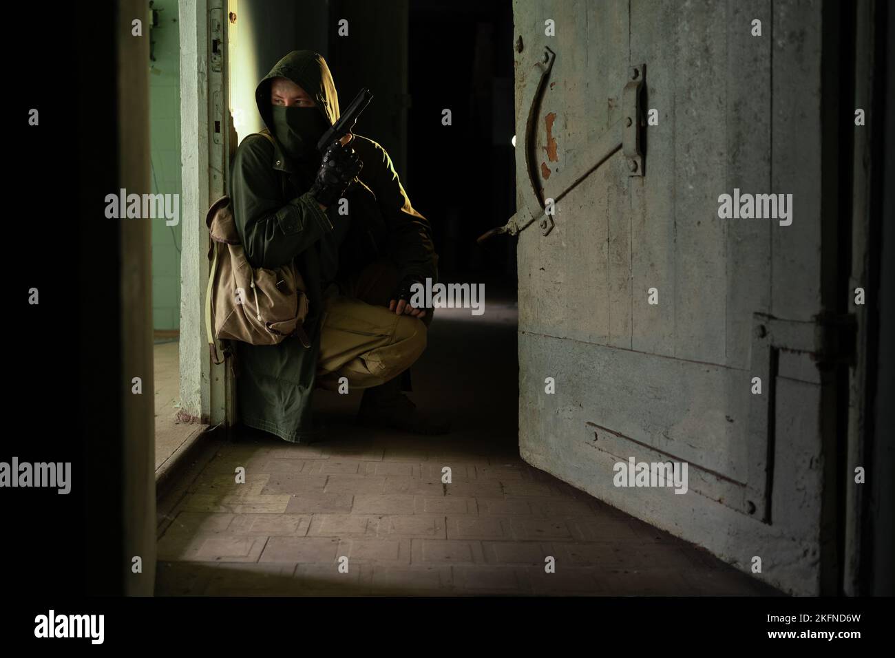 A post apocalypse soldier or stalker on a abandoned area with a gun and ...