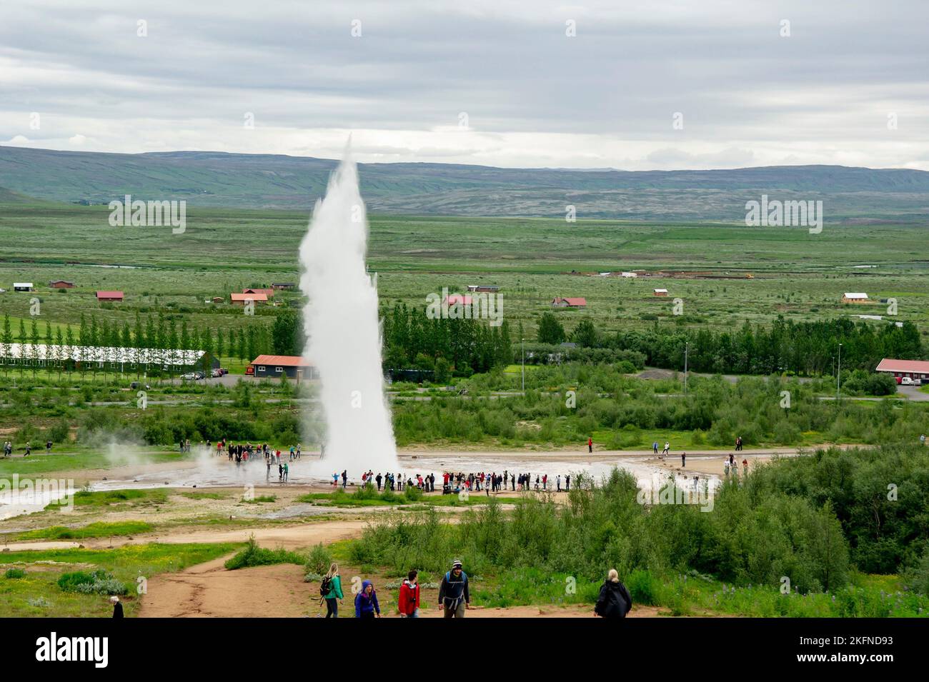 GEYSIR, ICELAND JUNE 28, 2014 Geysir eruption with tourist walking