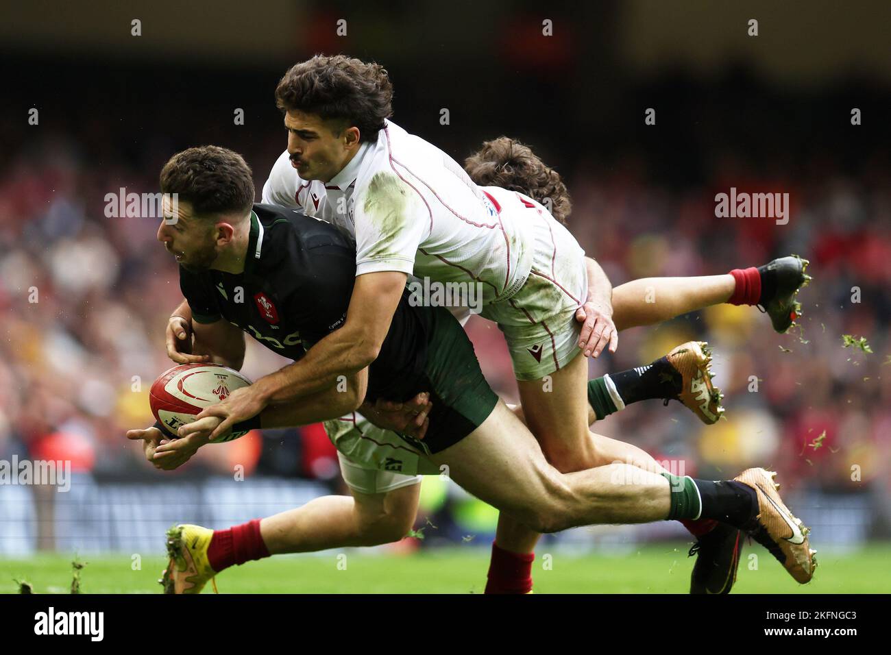 Cardiff, UK. 19th Nov, 2022. Alex Cuthbert of Wales is tackled by Davit Niniashvili of Georgia. Autumn nations series 2022 rugby match, Wales v Georgia at the Principality Stadium in Cardiff on Saturday 19th November 2022. pic by Andrew Orchard/Andrew Orchard sports photography/Alamy Live News Credit: Andrew Orchard sports photography/Alamy Live News Stock Photo