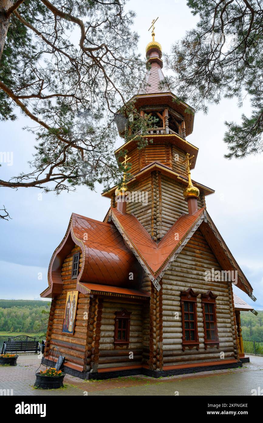 View of the wooden Christian Orthodox Church against the rainy sky in Siberia, Russia Stock Photo