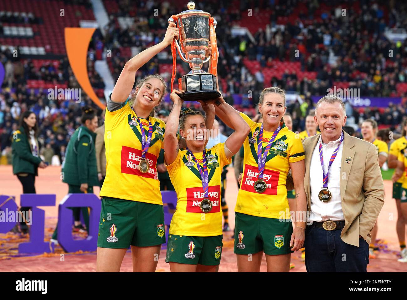Australia's Samantha Bremner (centre), Kezie Apps (left), Ali Brigginshaw and coach Brad Donald celebrate with the trophy after victory the Women's Rugby League World Cup final at Old Trafford, Manchester. Picture date: Saturday November 19, 2022. Stock Photo