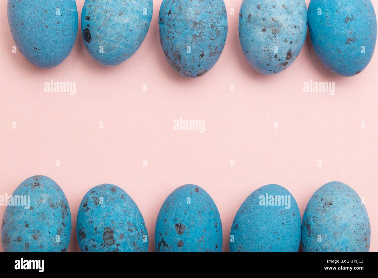 Blue Easter Eggs in a Row Forming a Frame on Pink Background with Copy Space Stock Photo
