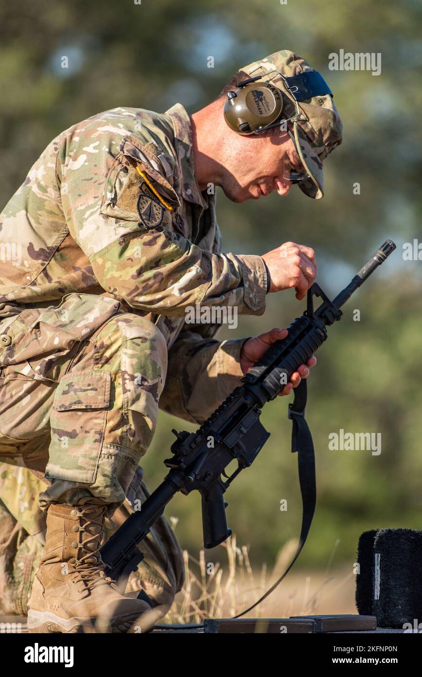 Sergeant 1st Class Jason E. Pate, 68W Combat Medics, 187th Medical Battalion, adjusts his front sight  during the best medic competition M4 rifle stress shoot qualifications, Sep. 29, 2022 at Joint Base San Antonio-Camp Bullis, Tx. The event included the Army Combat Fitness Test, obstacle course, M-4 qualification, warrior tasks and battle drills, land navigation, a Tactical Combat Casualty Care assessment and 12-Mile Ruck March. Stock Photo