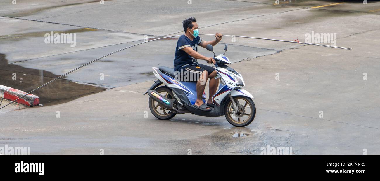 SAMUT PRAKAN, THAILAND, SEP 23 2022, A man rides a motorcycle with